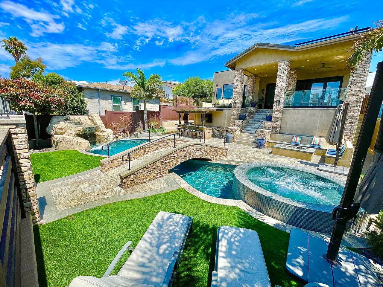 Rear elevation with pool, spa, and landscaped lawn
