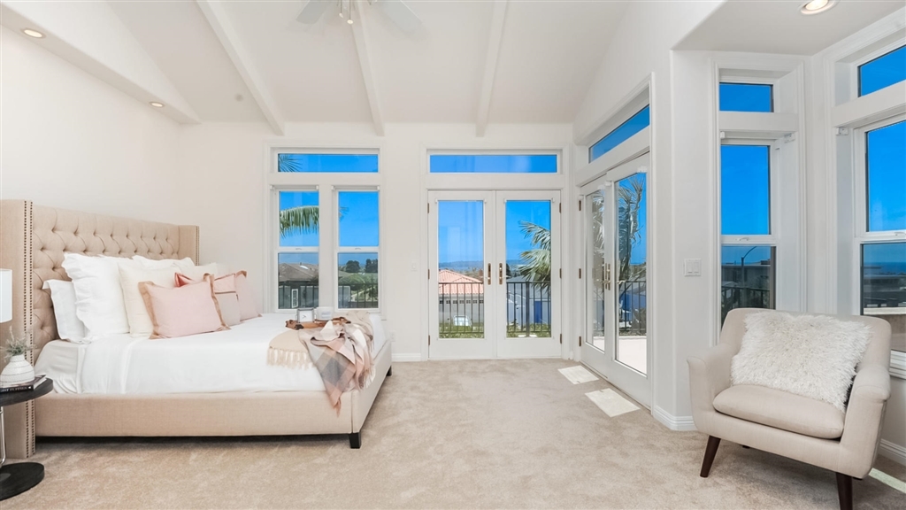 Primary bedroom with white-water views and French doors
